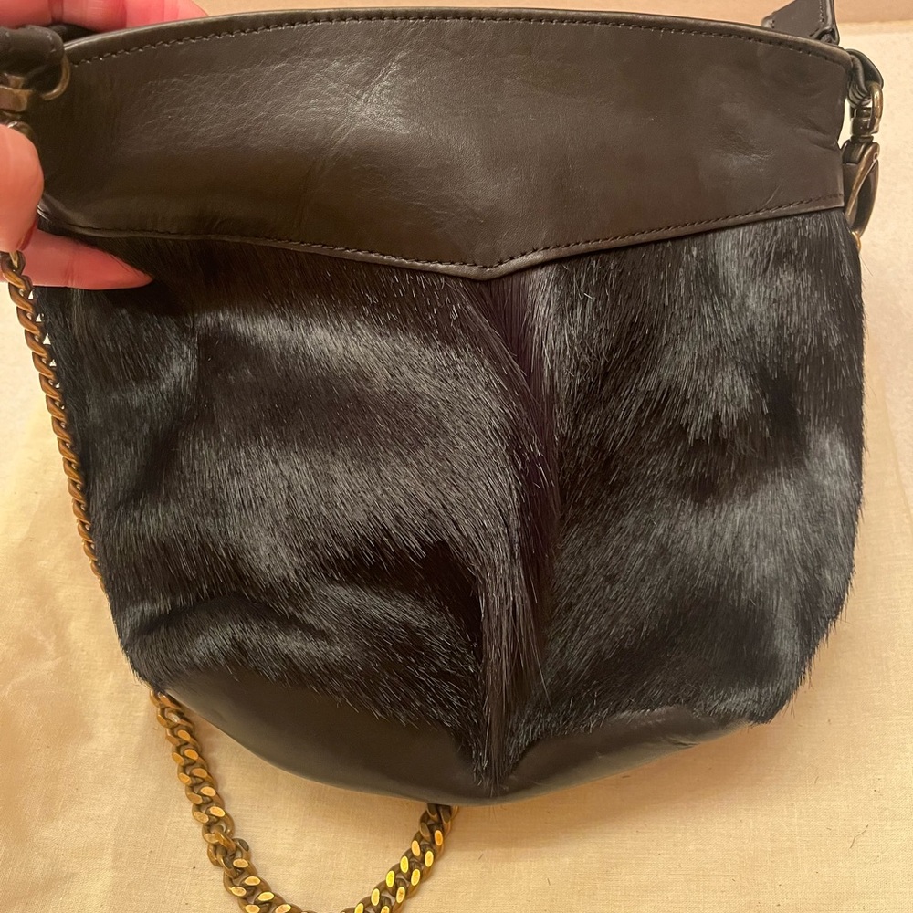 Black shoulder bag with fur and leather.